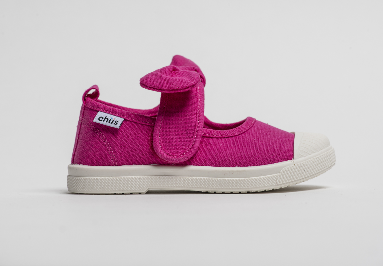 Canvas sneakers with single velcro strap and removable bow tie in fuchsia / hot pink. Adorable monogrammed. Chus Shoes. Side view.