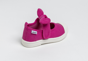 Canvas sneakers with single velcro strap and removable bow tie in fuchsia / hot pink. Adorable monogrammed. Chus Shoes. Back view.