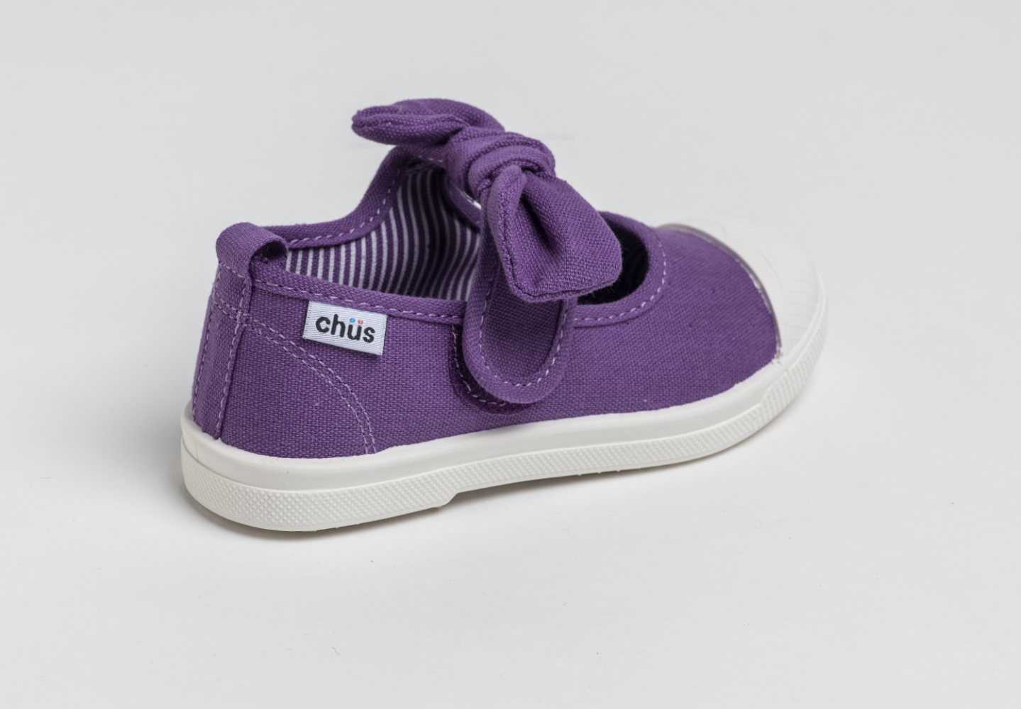 Canvas sneakers with single velcro strap and removable bow tie in purple. Adorable monogrammed. Chus Shoes. Back view.