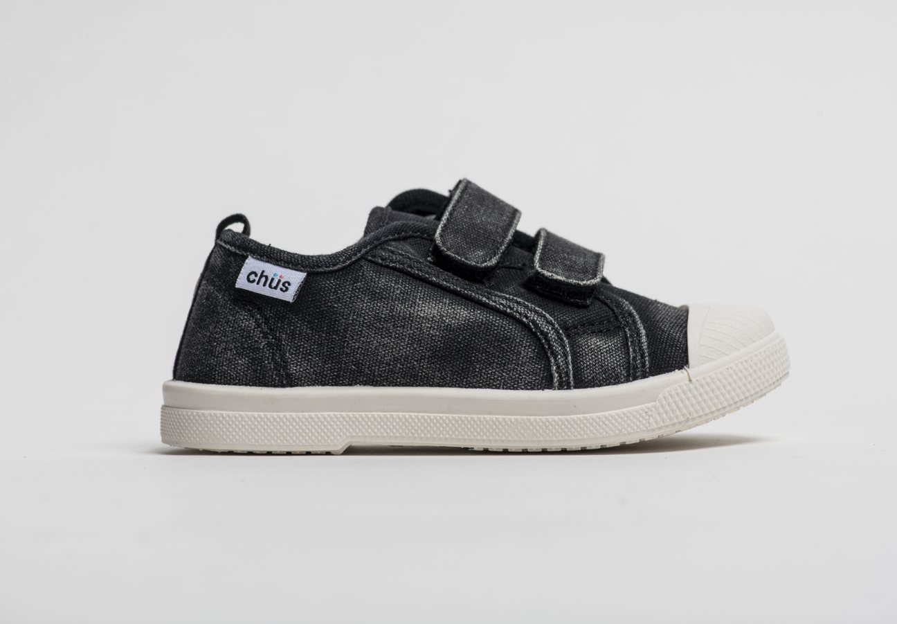 Distressed black canvas sneakers with double velcro straps. Chus Shoes. Side view.