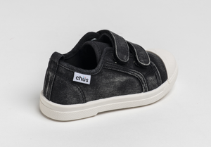 Distressed black canvas sneakers with double velcro straps. Chus Shoes. Back view.