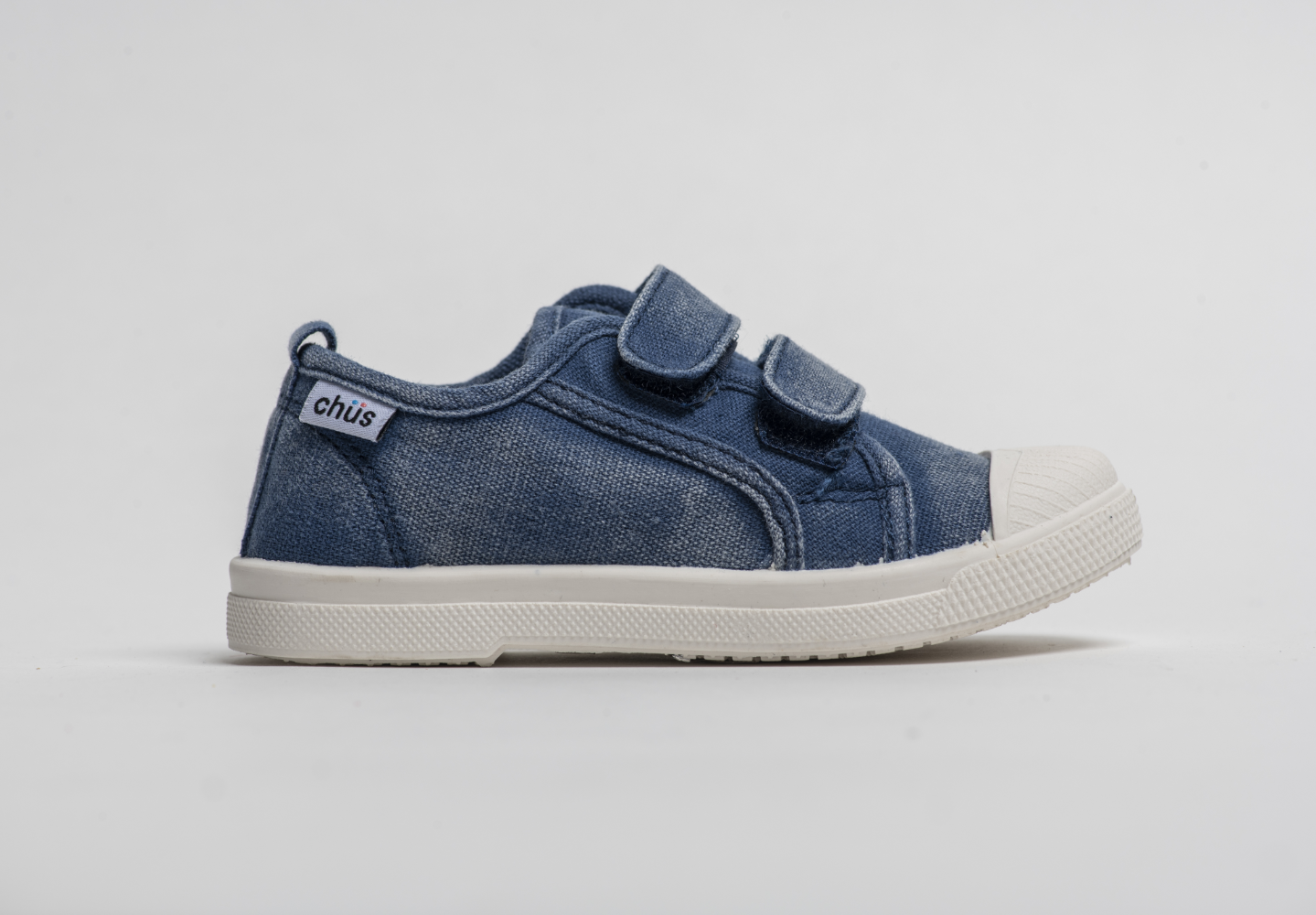 Distressed navy canvas sneakers with double velcro straps. Chus Shoes. Side View.
